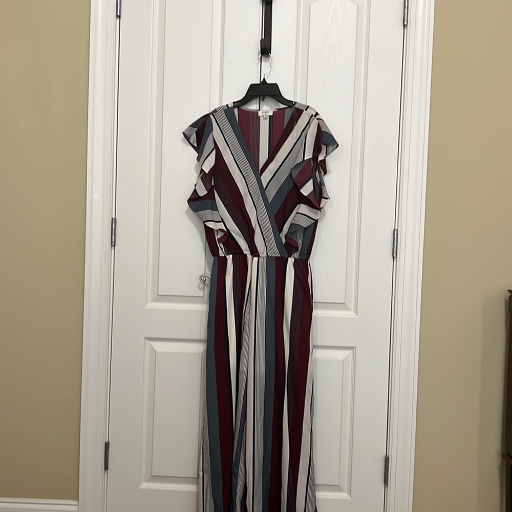 You will love this striped jumpsuit with curvy flare shoulders.